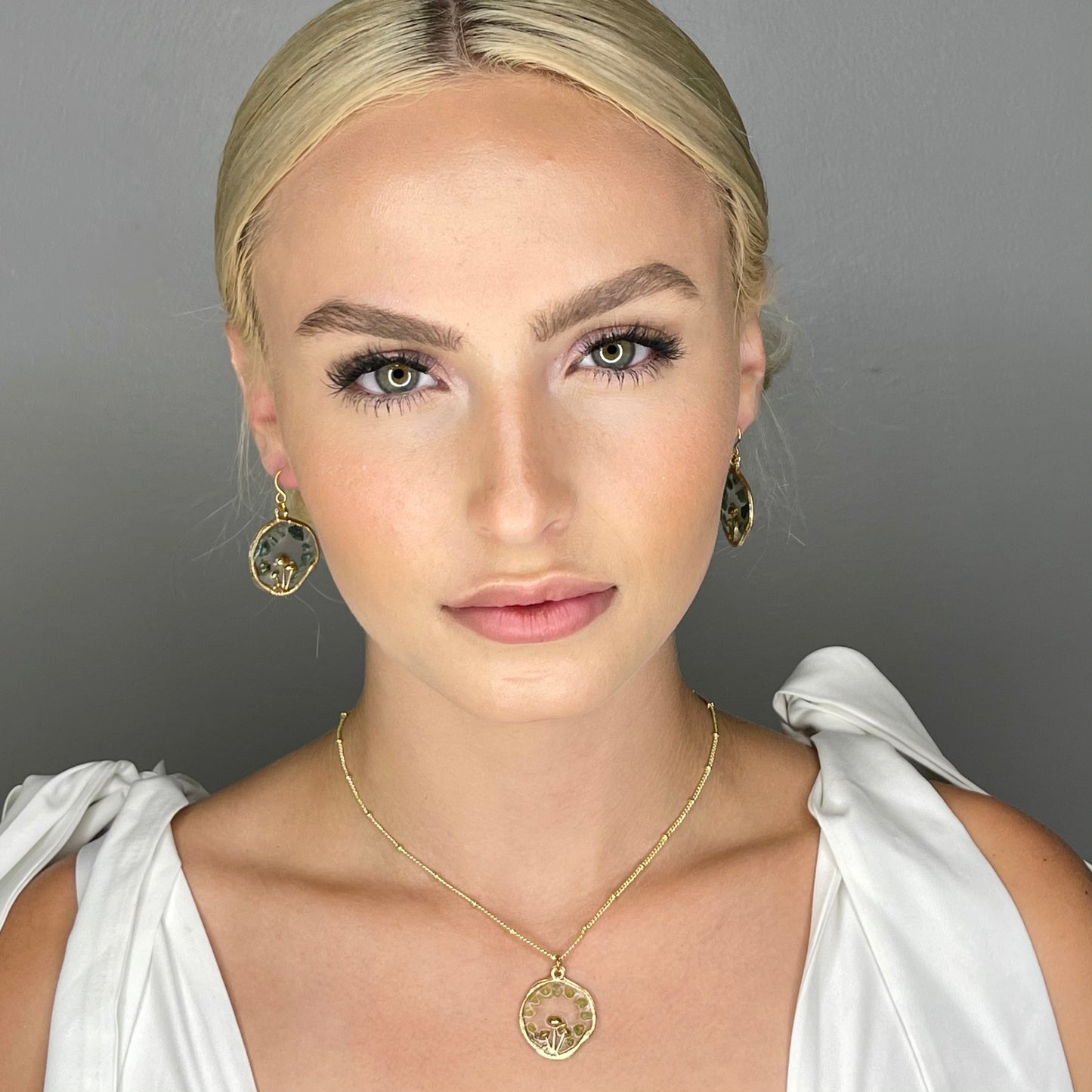 model wearing moss agate mushroom earrings gold earrings