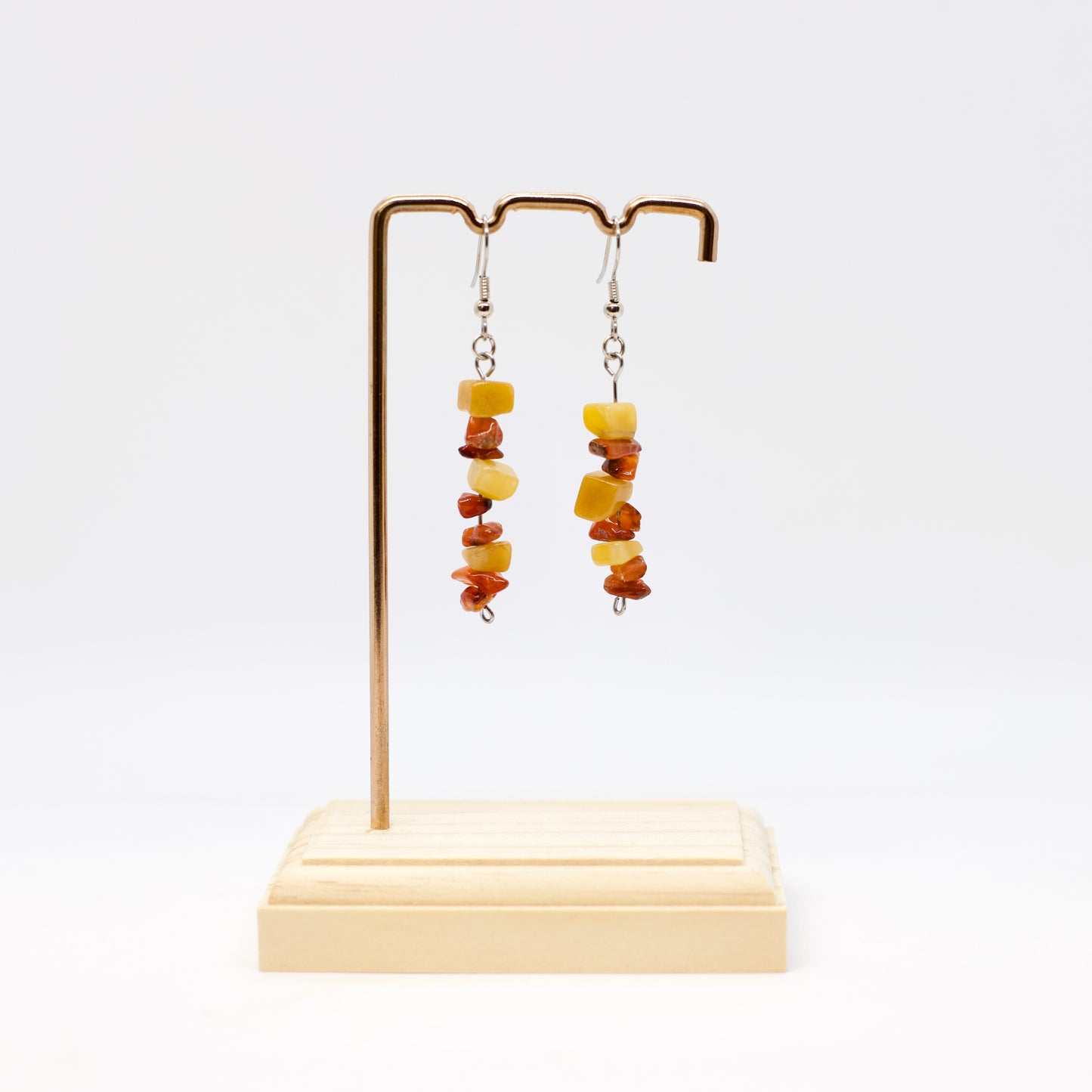 Carnelian and Yellow Aventurine Gemstone Earrings on display stand with white background