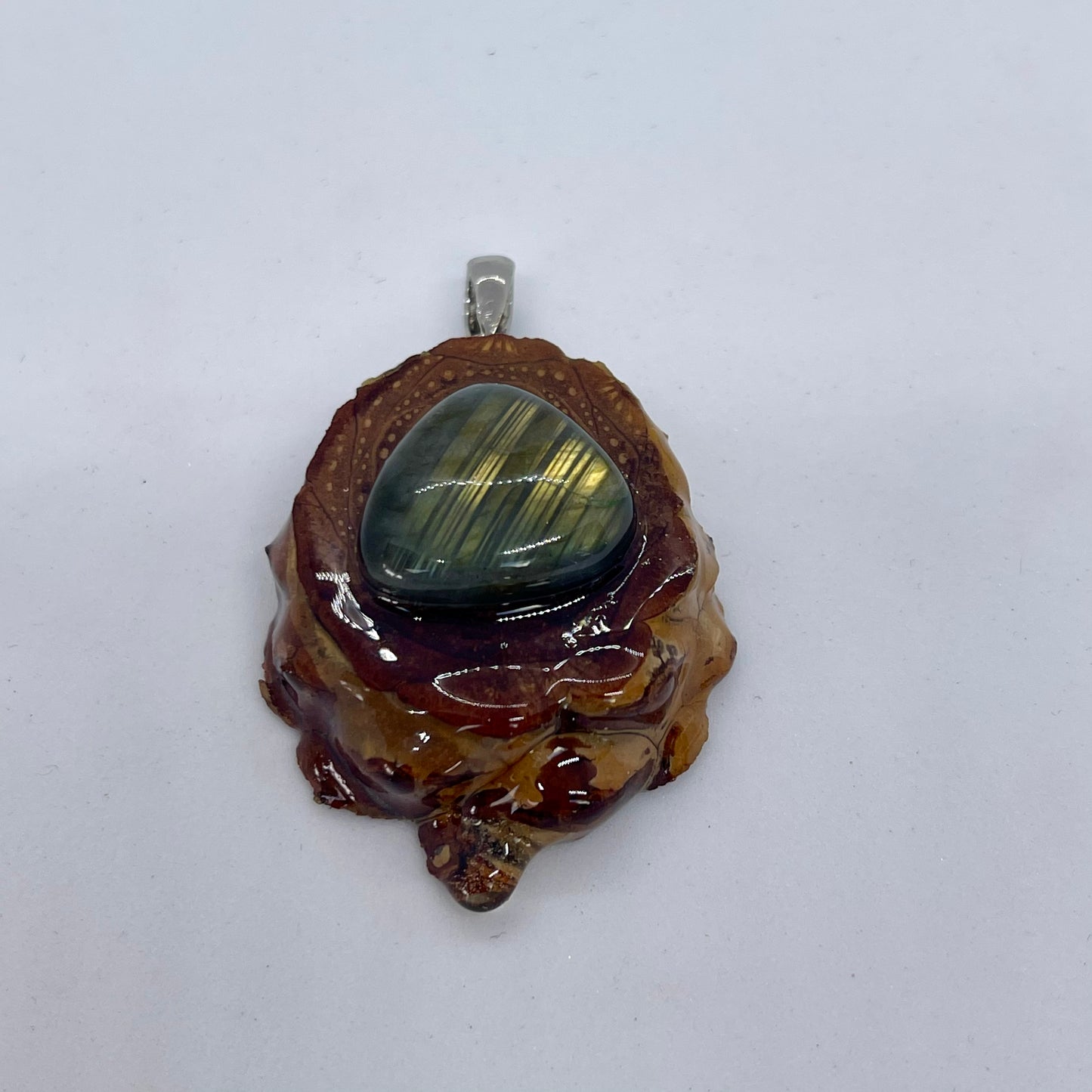 close up of flash from crystal pinecone pendant with labradorite gemstone
