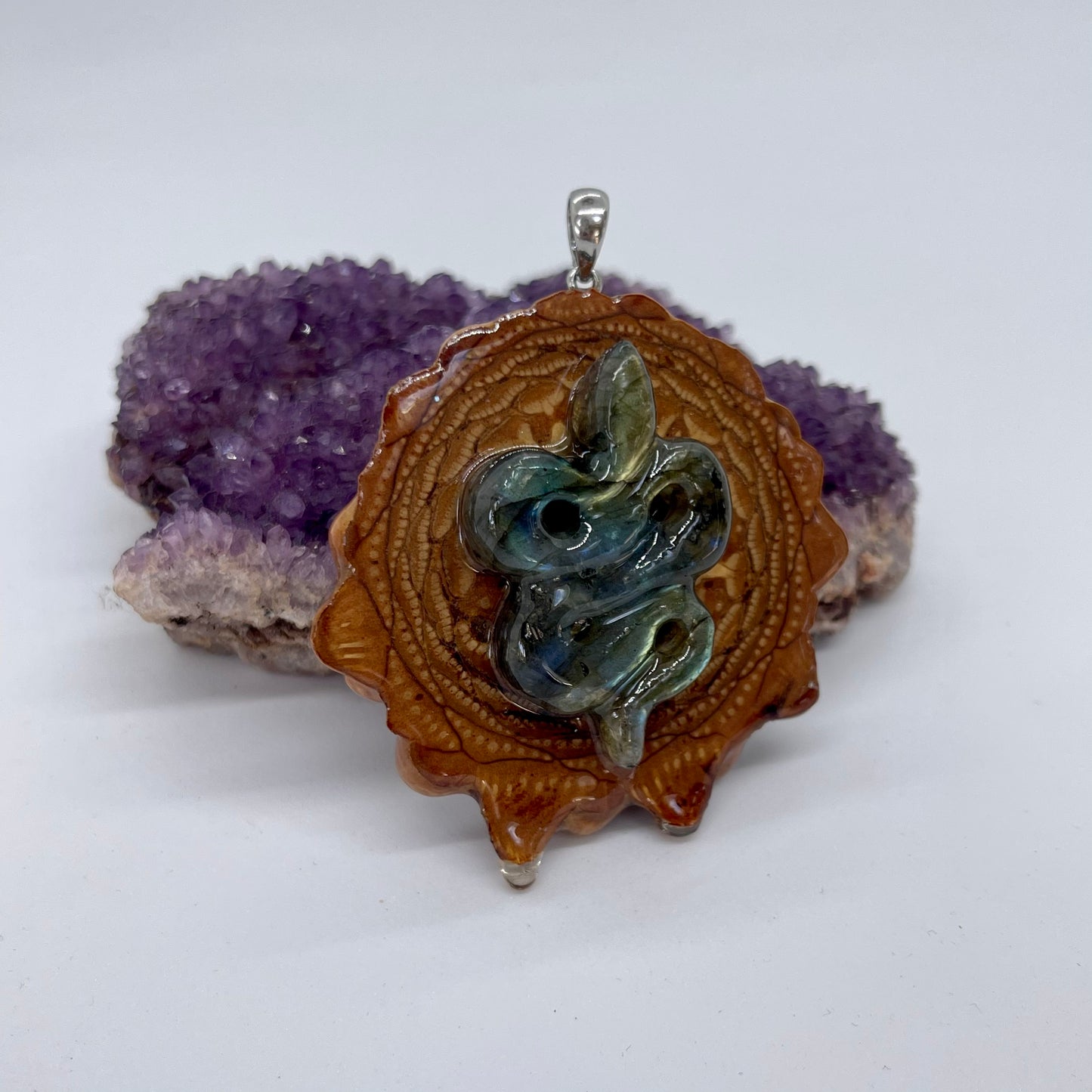 sideview of pinecone pendant with labradorite snake and silver bail
