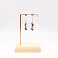 chakra gemstone earrings on display stand
