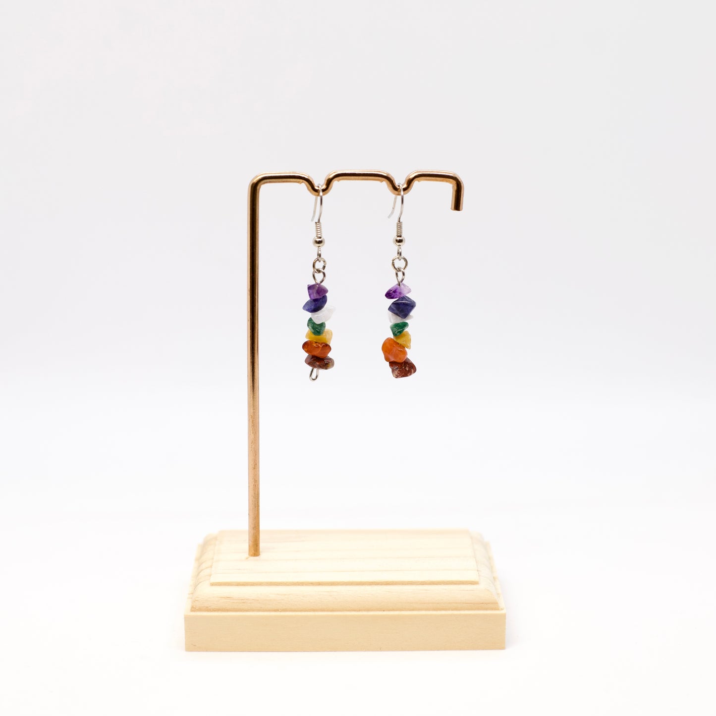 chakra gemstone earrings on display stand
