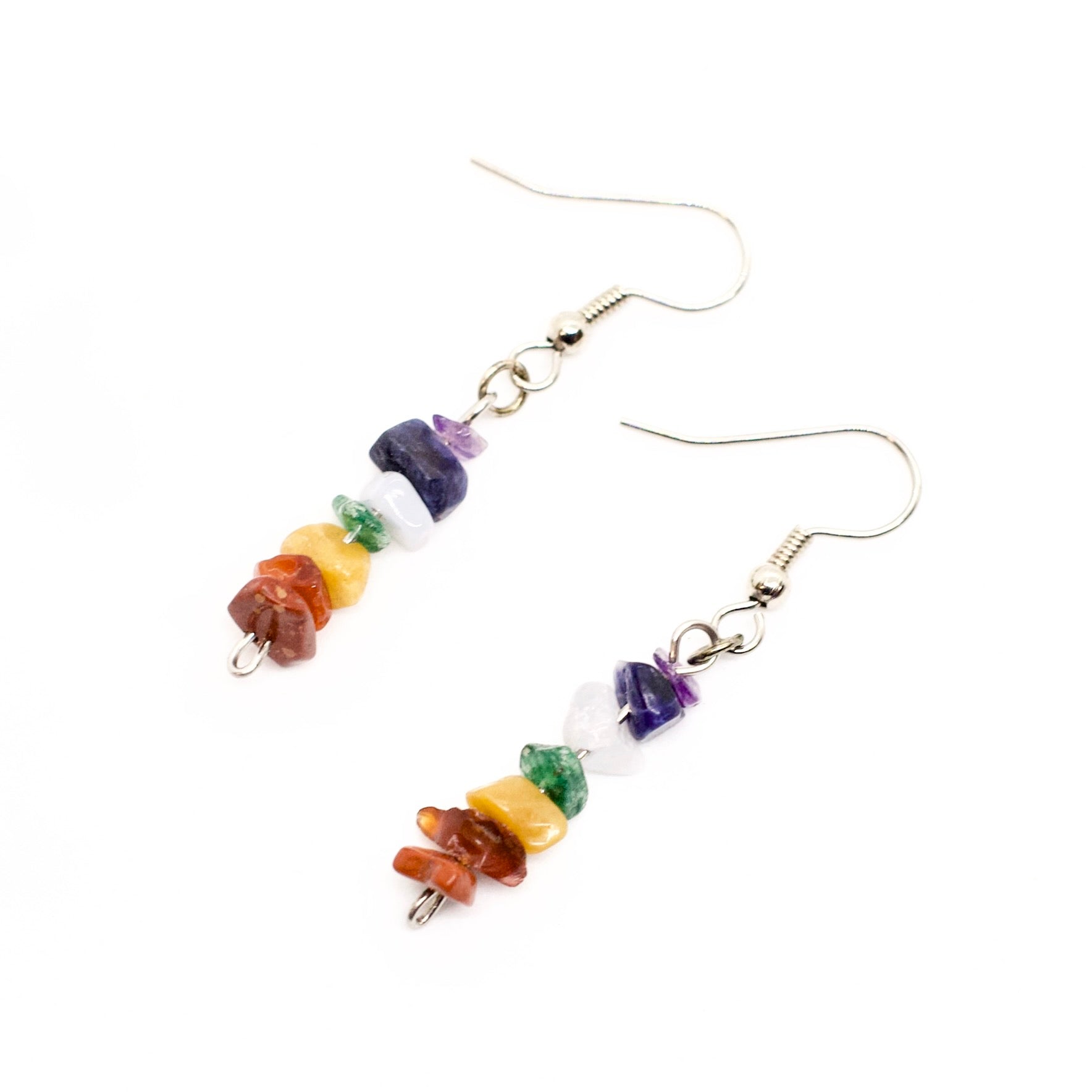 Chakra gemstone chip dangle earrings displayed on white background