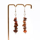 red jasper gemstone chip dangle earrings on display stand 