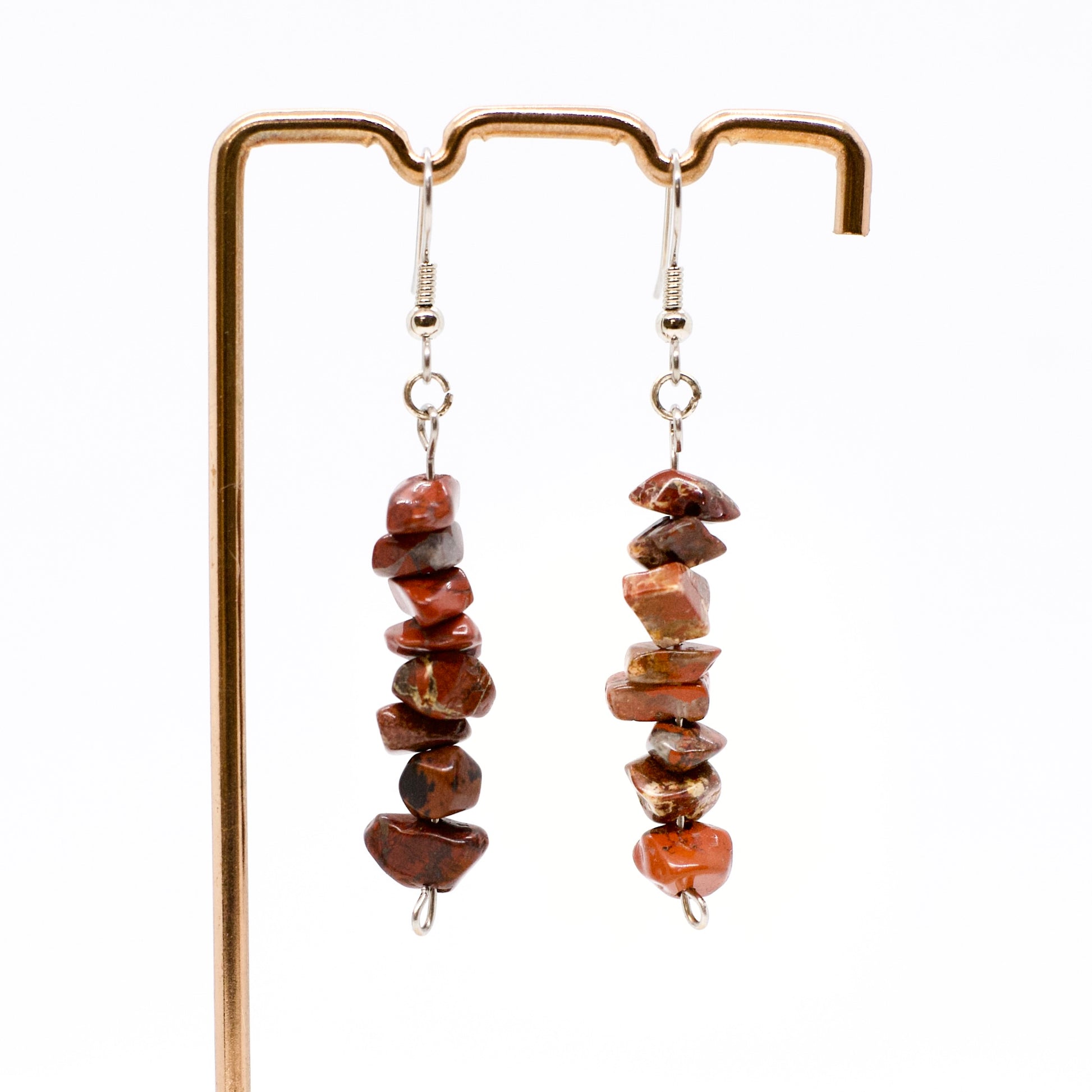 red jasper gemstone chip dangle earrings on display stand 