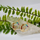 Chakra mushroom earrings with crystal chips display on crystal with plant background