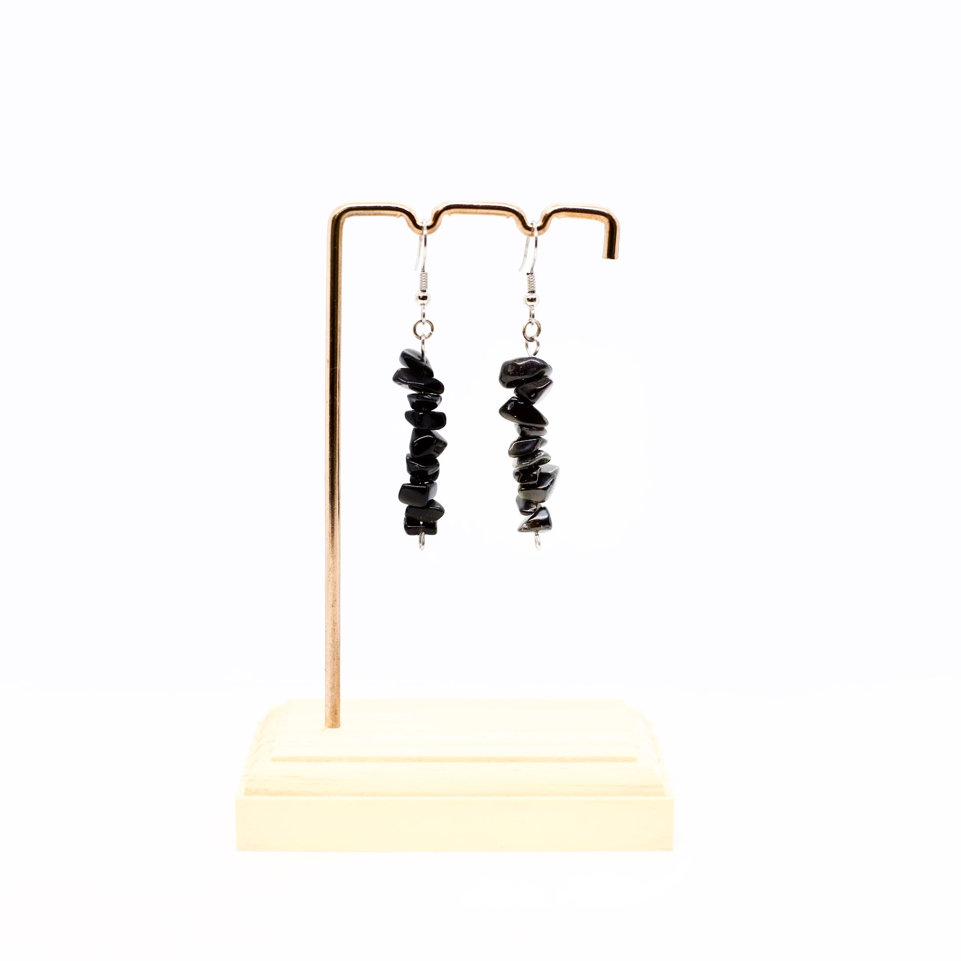 Obsidian gemstone chip dangle earrings on display stand 