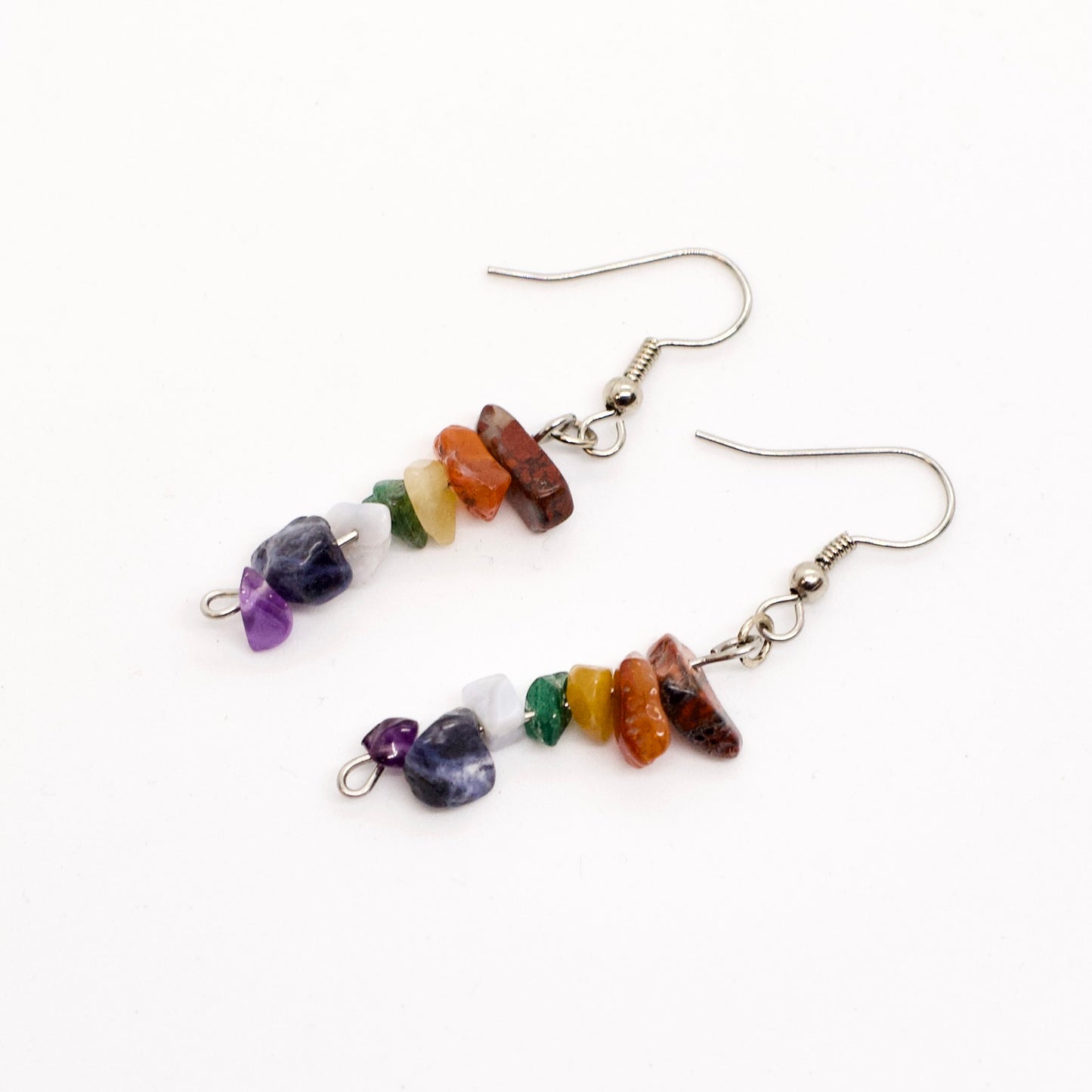 chakra gemstone chip dangle earrings on white background