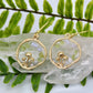 Peridot and Blue lace agate gemstone chips in gold mushroom earrings displayed on crystal 