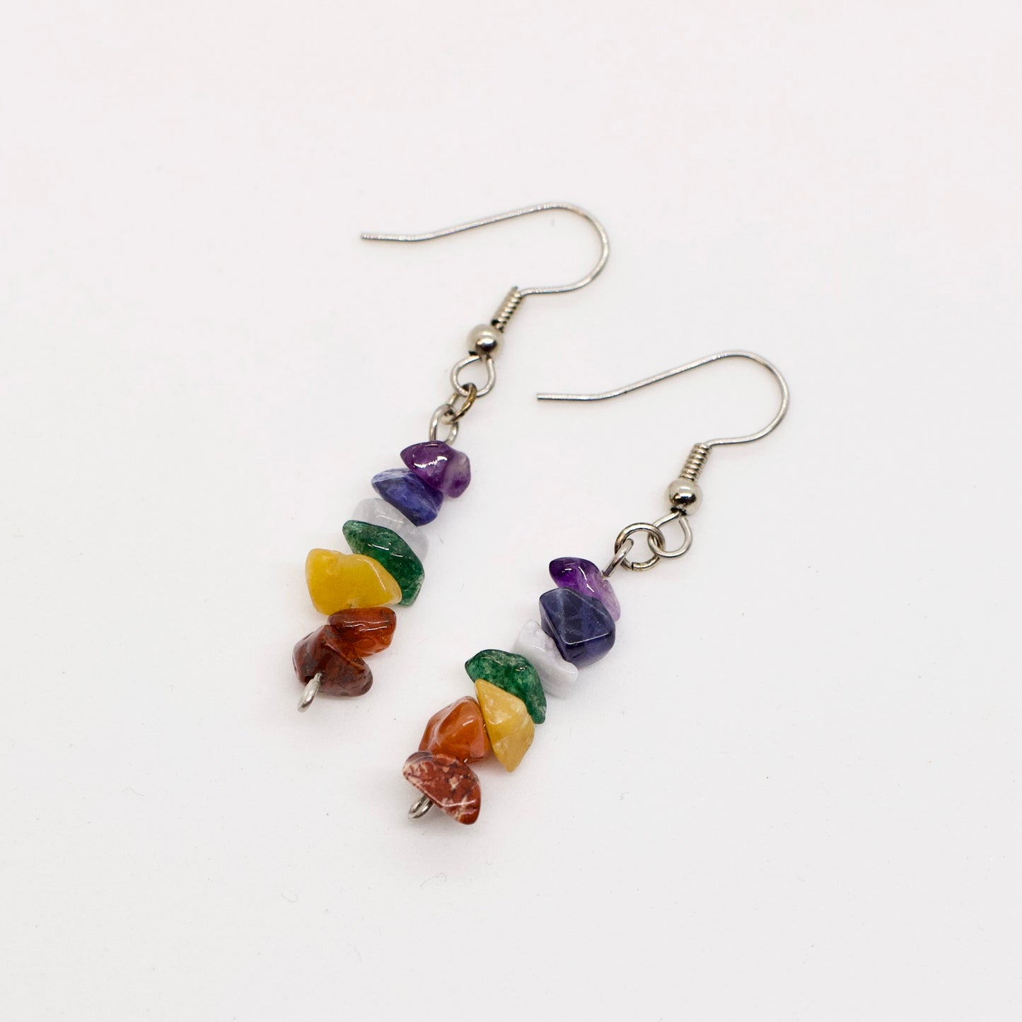 chakra dangle earrings on white background