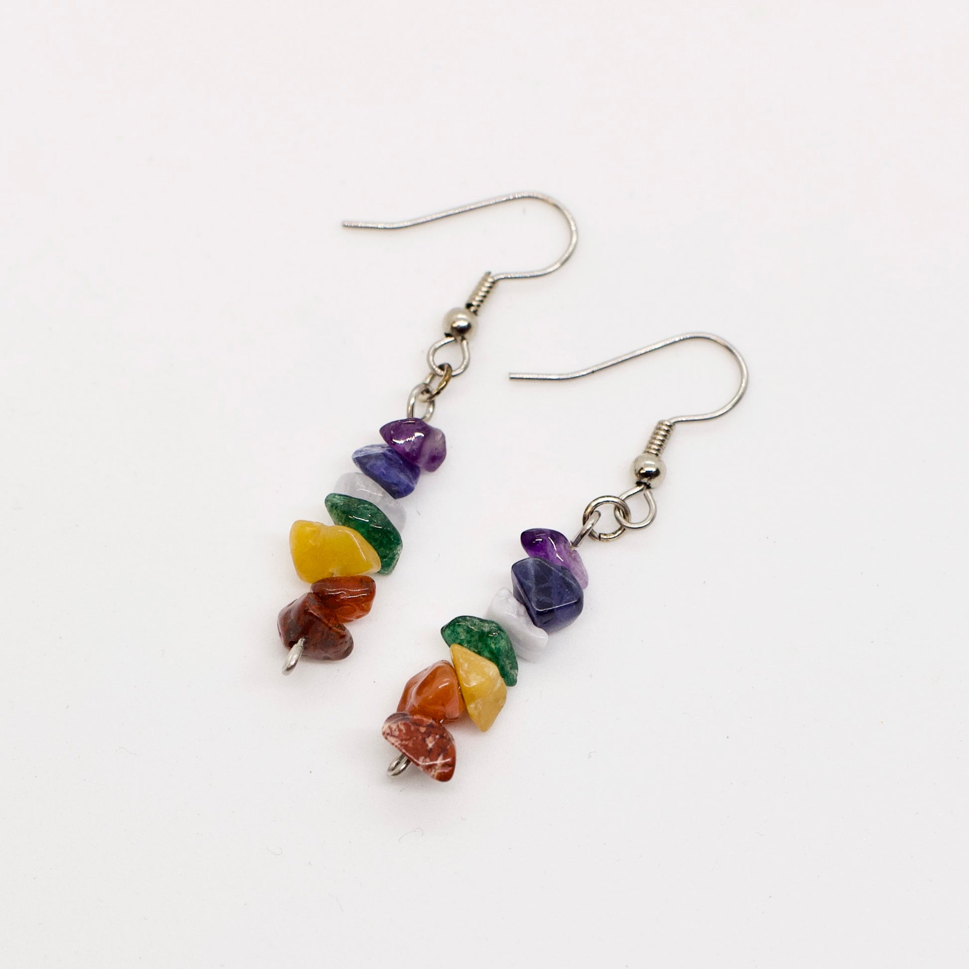 chakra dangle earrings on white background