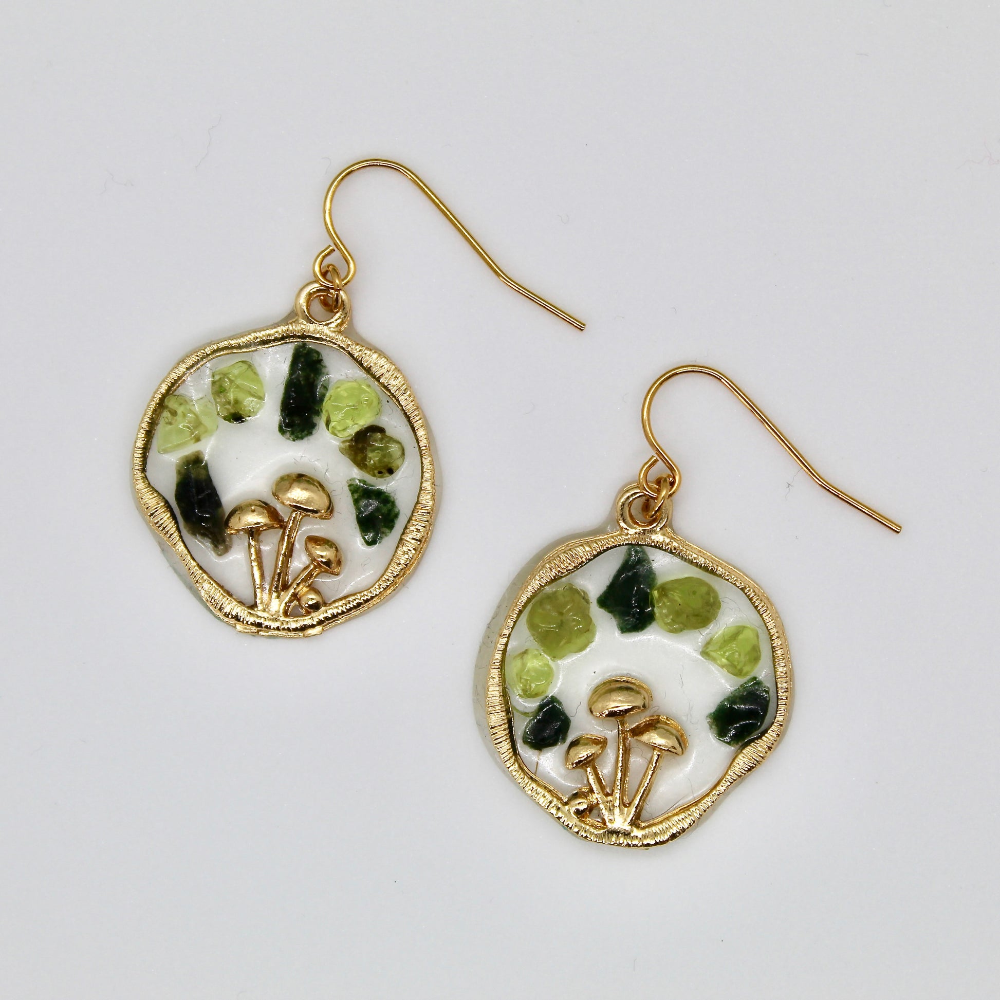 gold mushroom earrings with moss agate and peridot crystal gemstone chips on white background