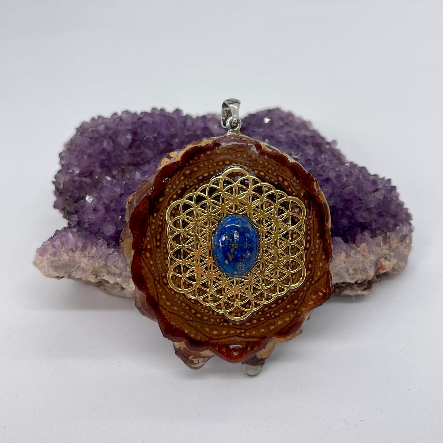 pinecone pendant with silver bail and lapis lazuli stone on flower of life symbol