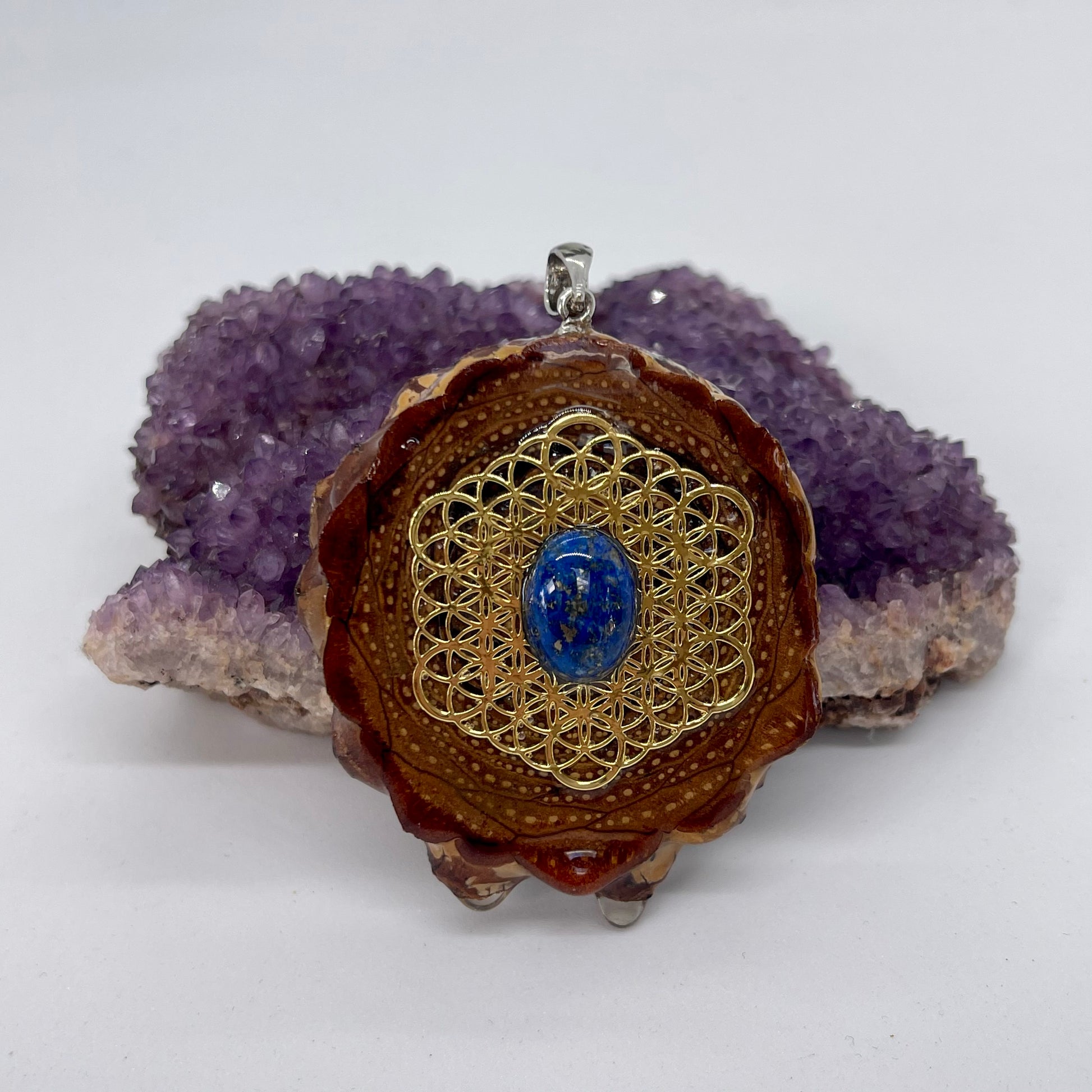 pinecone pendant with silver bail and lapis lazuli stone on flower of life symbol