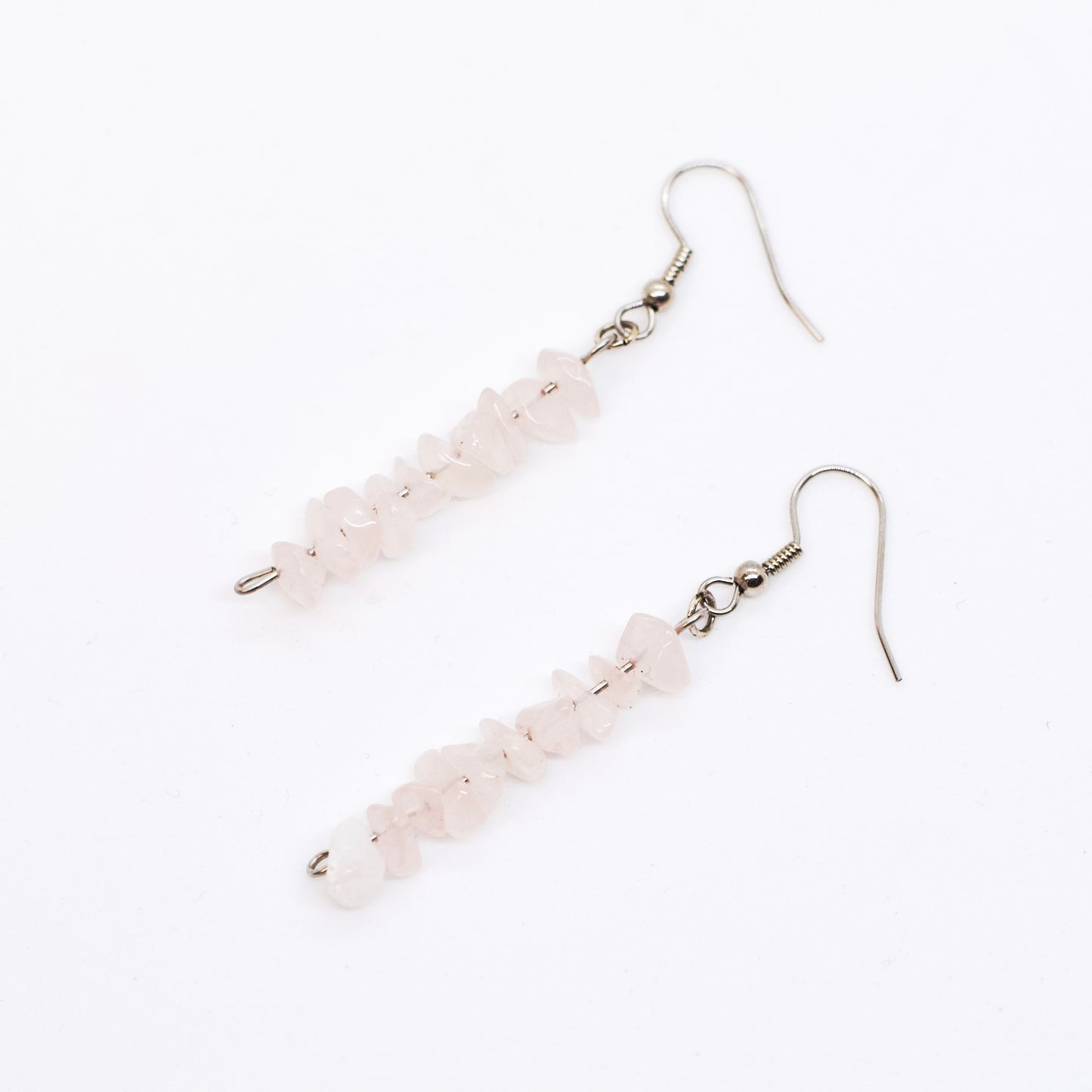 rose quartz gemstone chip dangle earrings on white background