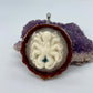 octopus pinecone pendant with crushed opal and silver bail displayed on crystal 