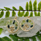 closeup of gold mushroom earring with peridot and moss agate gemstone chips 