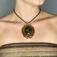 close up of model wearing kambaba jasper pinecone pendant 