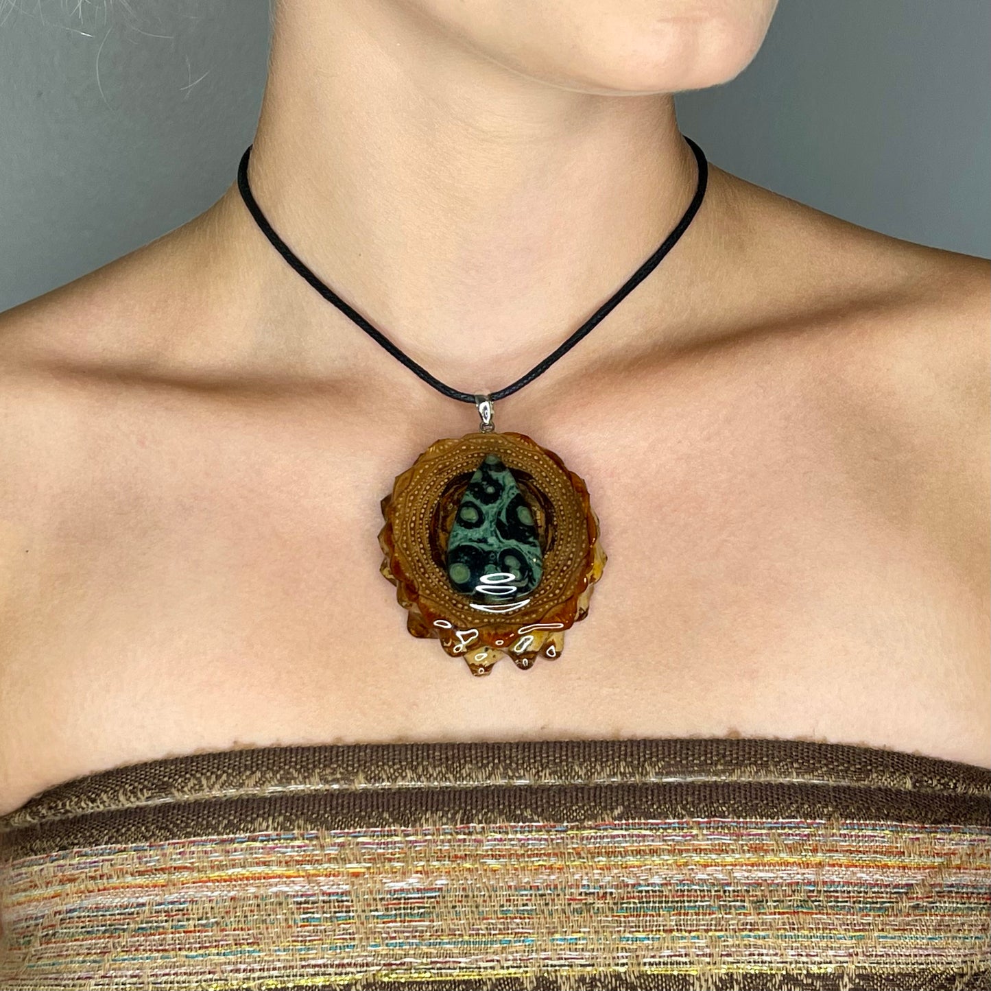 close up of model wearing kambaba jasper pinecone pendant 
