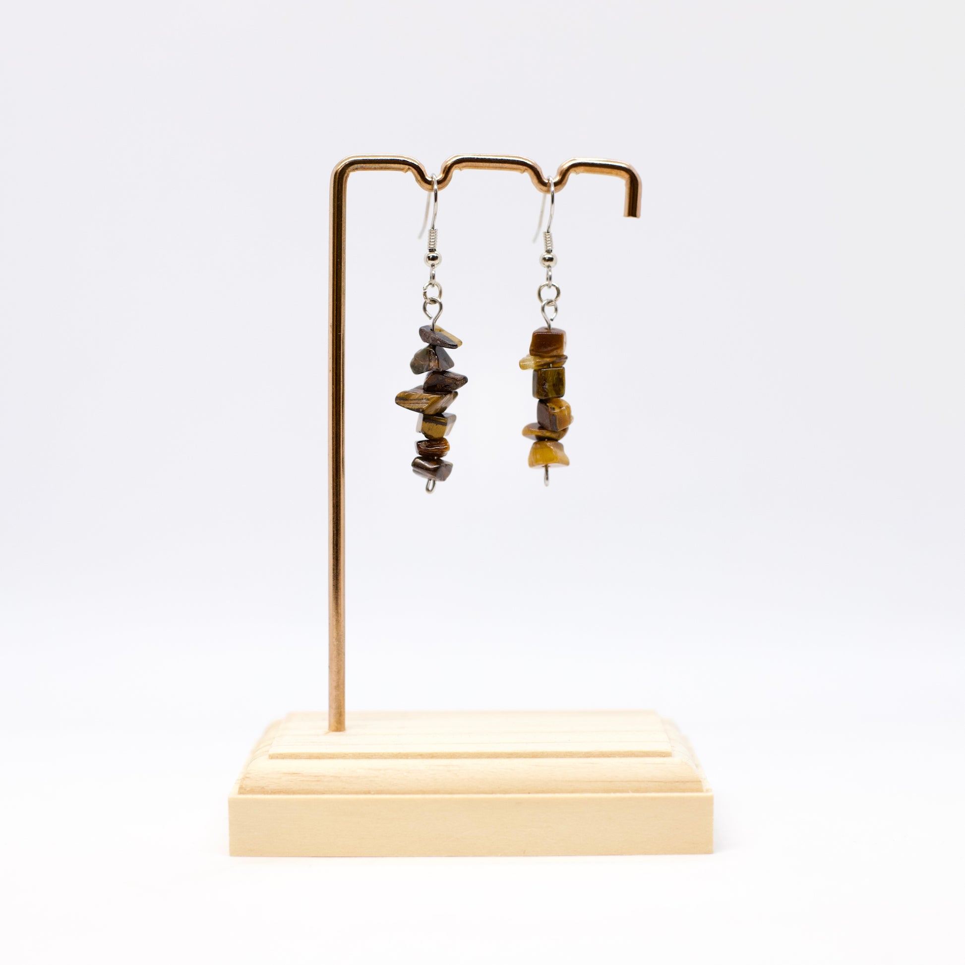 Tiger eye gemstone chip earrings on display stand
