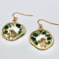 gold mushroom earrings with moss agate gemstone chips on white background