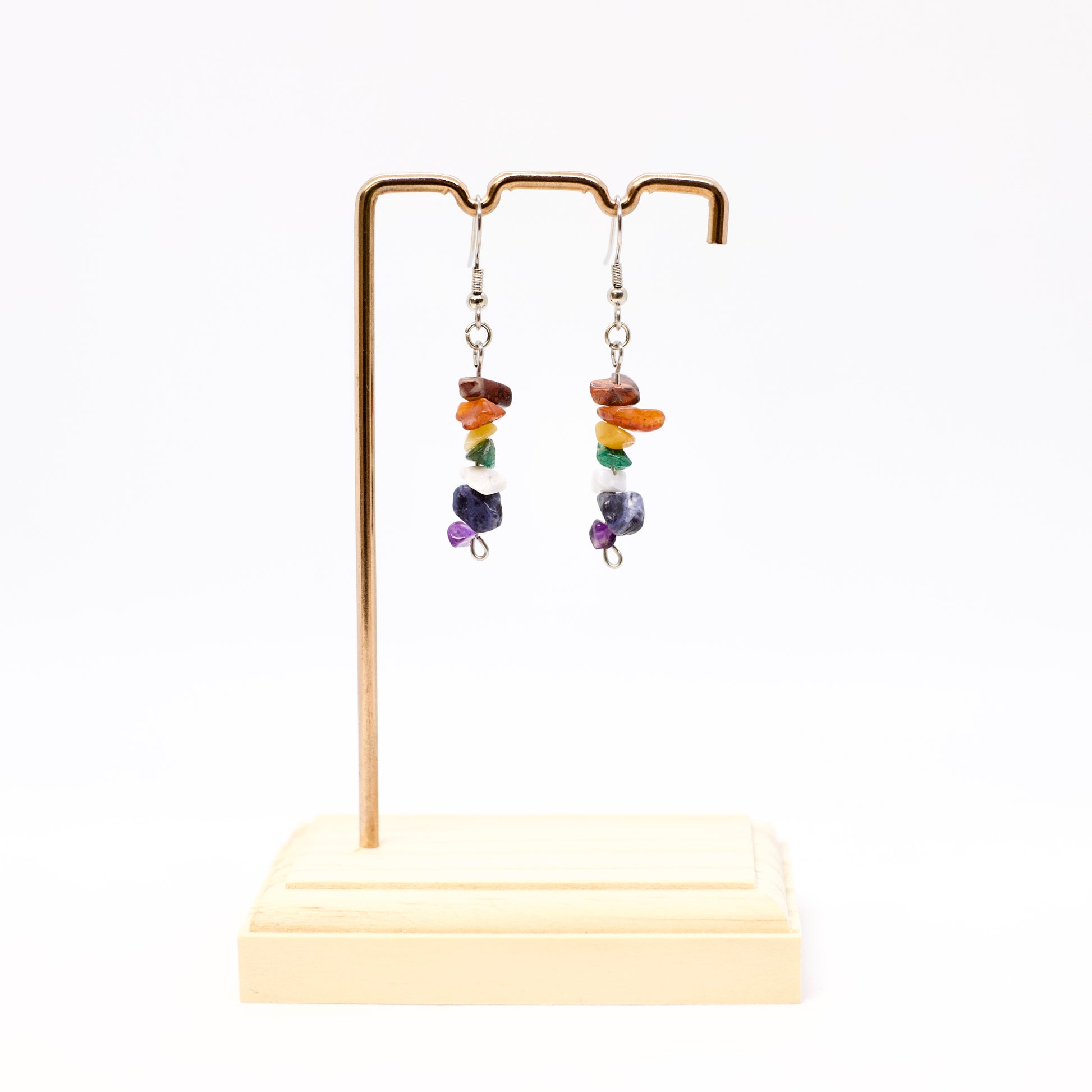 Chakra gemstone chip earrings on display stand 