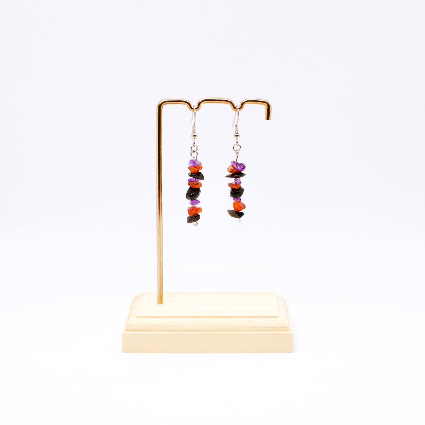 Amethyst Carnelian Obsidian gemstone dangle earrings on stand with white background 