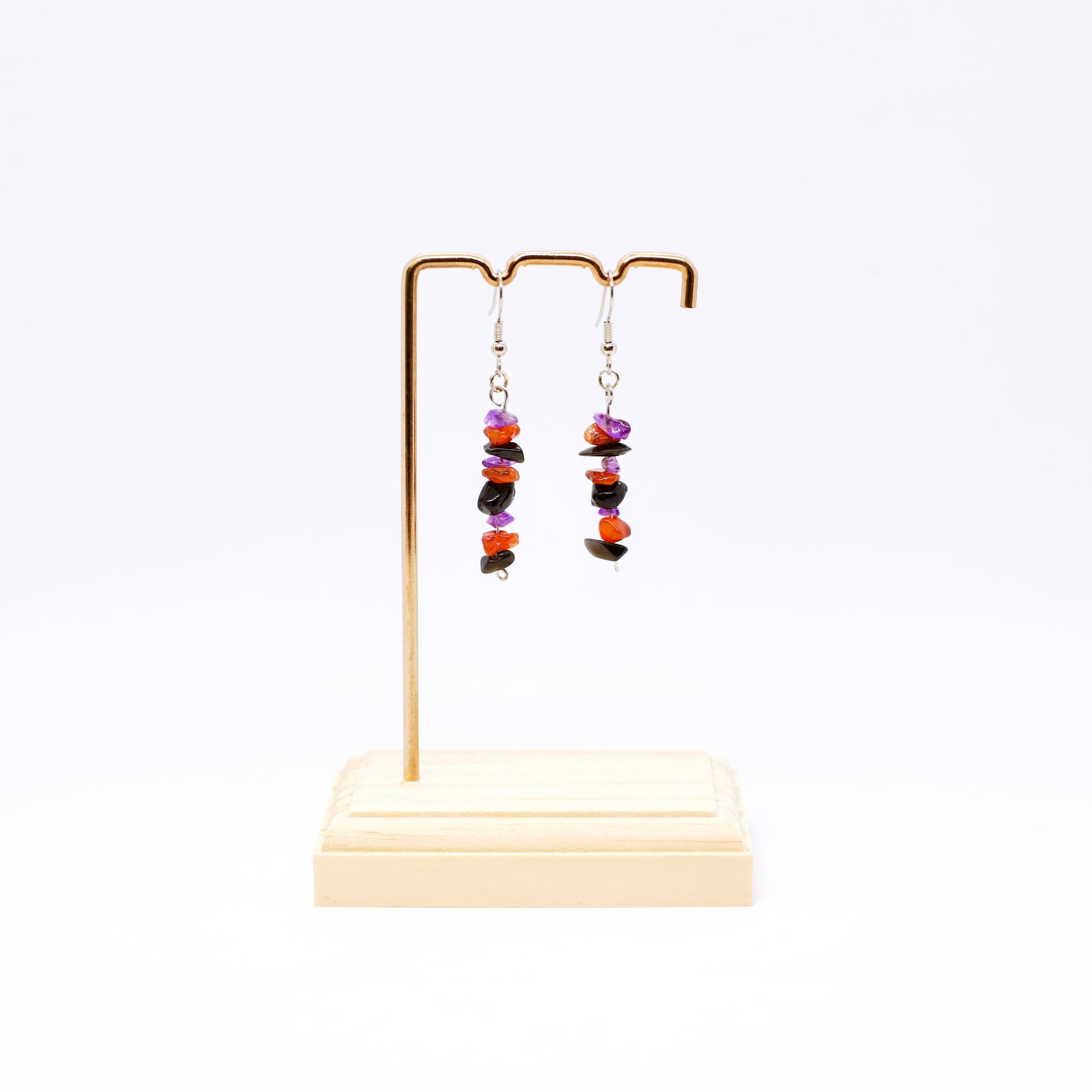 Amethyst Carnelian Obsidian gemstone dangle earrings on stand with white background 