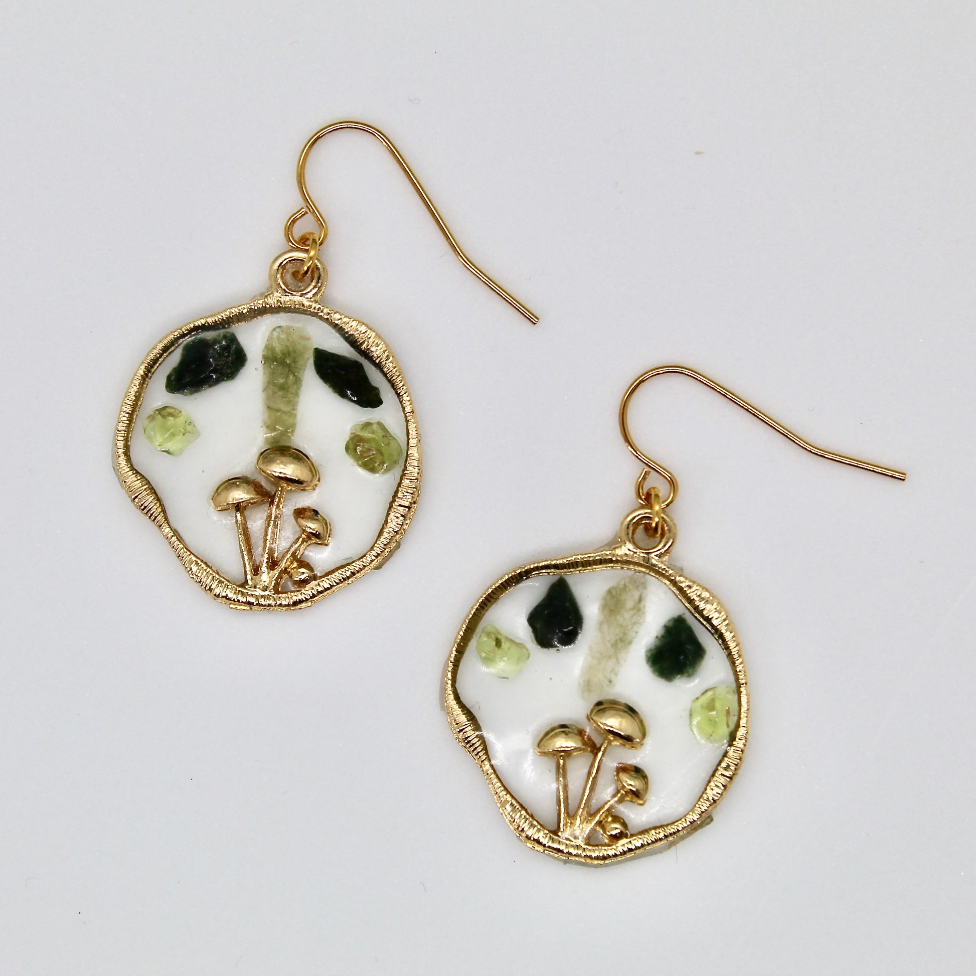 peridot and moss agate mushroom earrings on white background