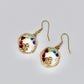 gold crystal mushroom earrings with chakra stones on white background