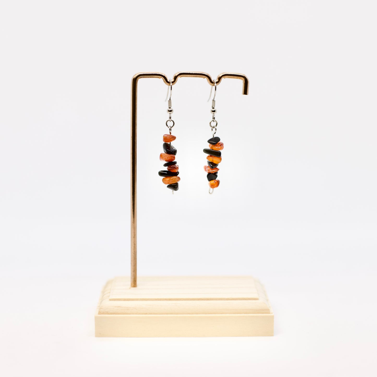 Carnelian and Obsidian gemstone chip earrings on display stand with white background 