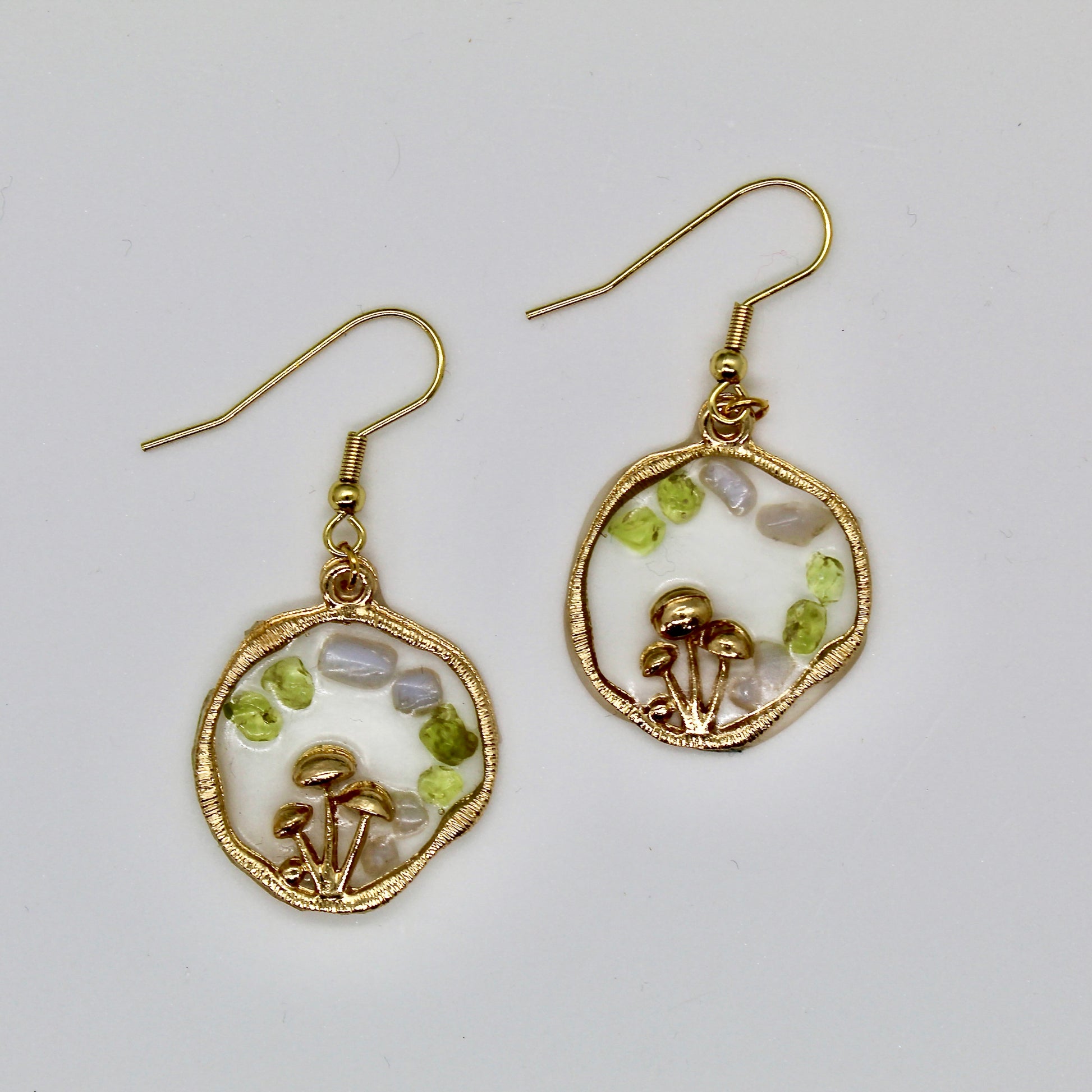 peridot and blue lace agate gemstone gold mushroom earrings on white background 
