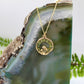 Gold msuhroom pendant with peridot gemstones on gold chain 