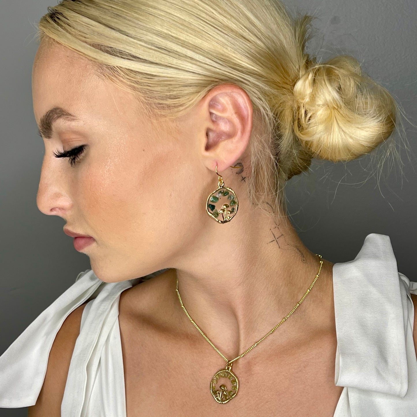 sideview of model wearing gold mushroom earrings 