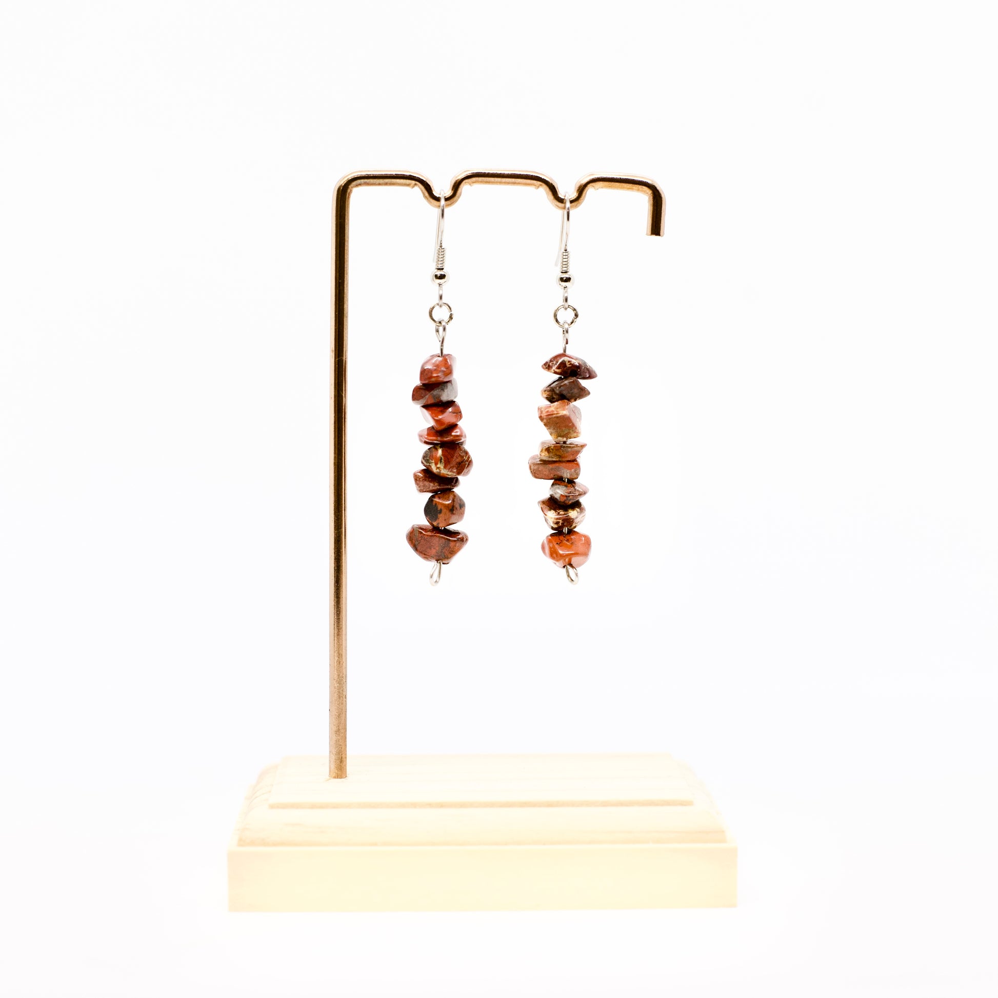 red jasper gemstone dangle earrings on display stand 