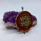 right side view of pinecone pendant with black Fire Opals and Metatron's Cube symbol displayed on crystal
