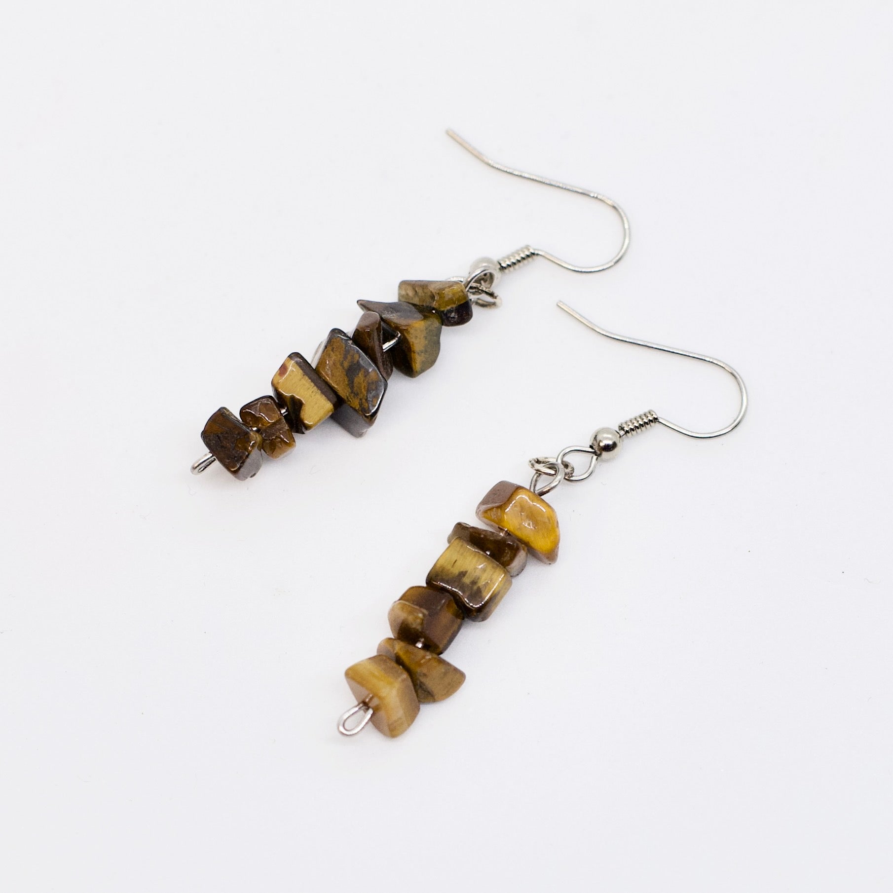 tiger eye gemstone chip dangle earrings on white background
