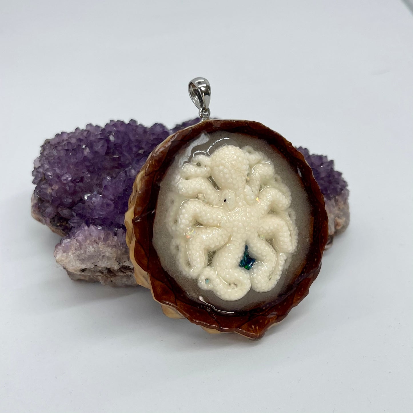 sideview od octopus pinecone pendant displayed on crystal 