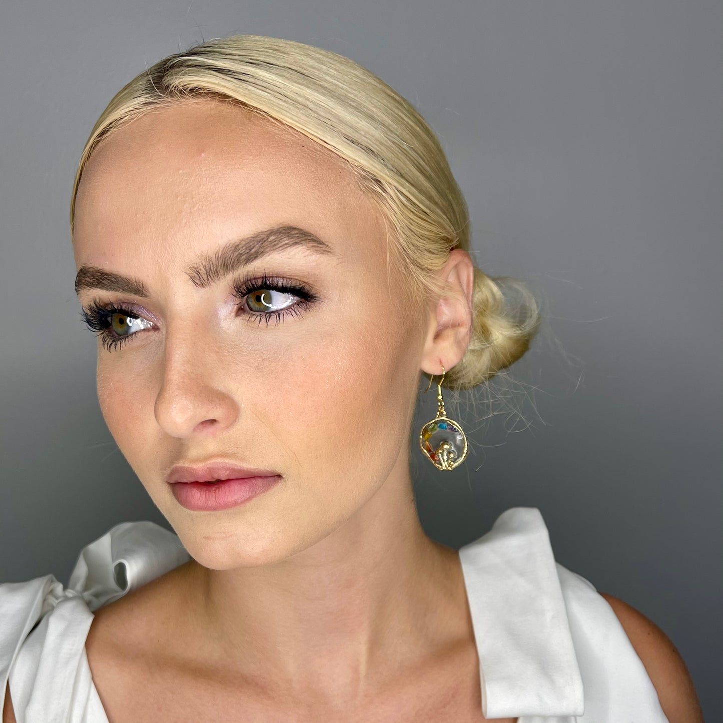 model looking to the side modeling chakra mushroom earrings 