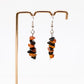 Carnelian and Obsidian gemstone earrings on display stand in front of white background