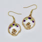 gold mushroom earrings with peridot and amethyst gemstone chips on white background 