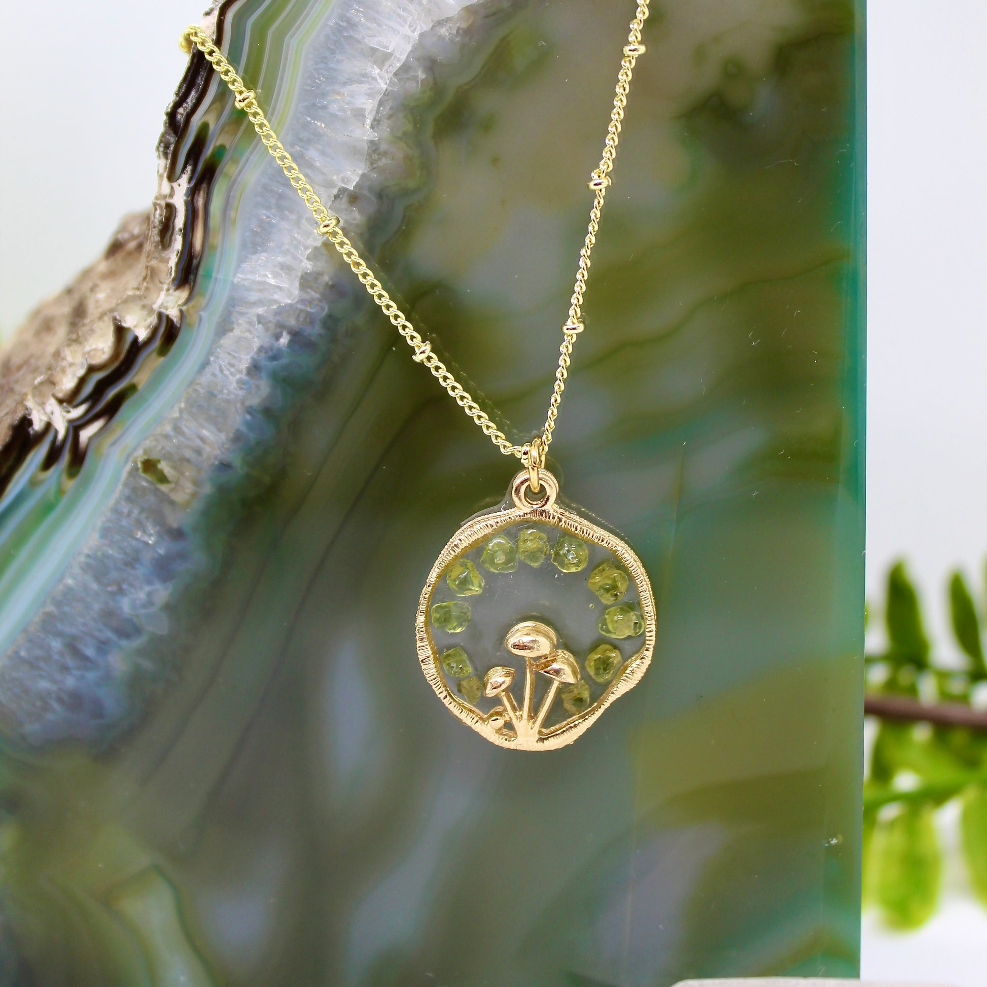 gold mushroom necklace with peridot gemstone chips and gold chain 