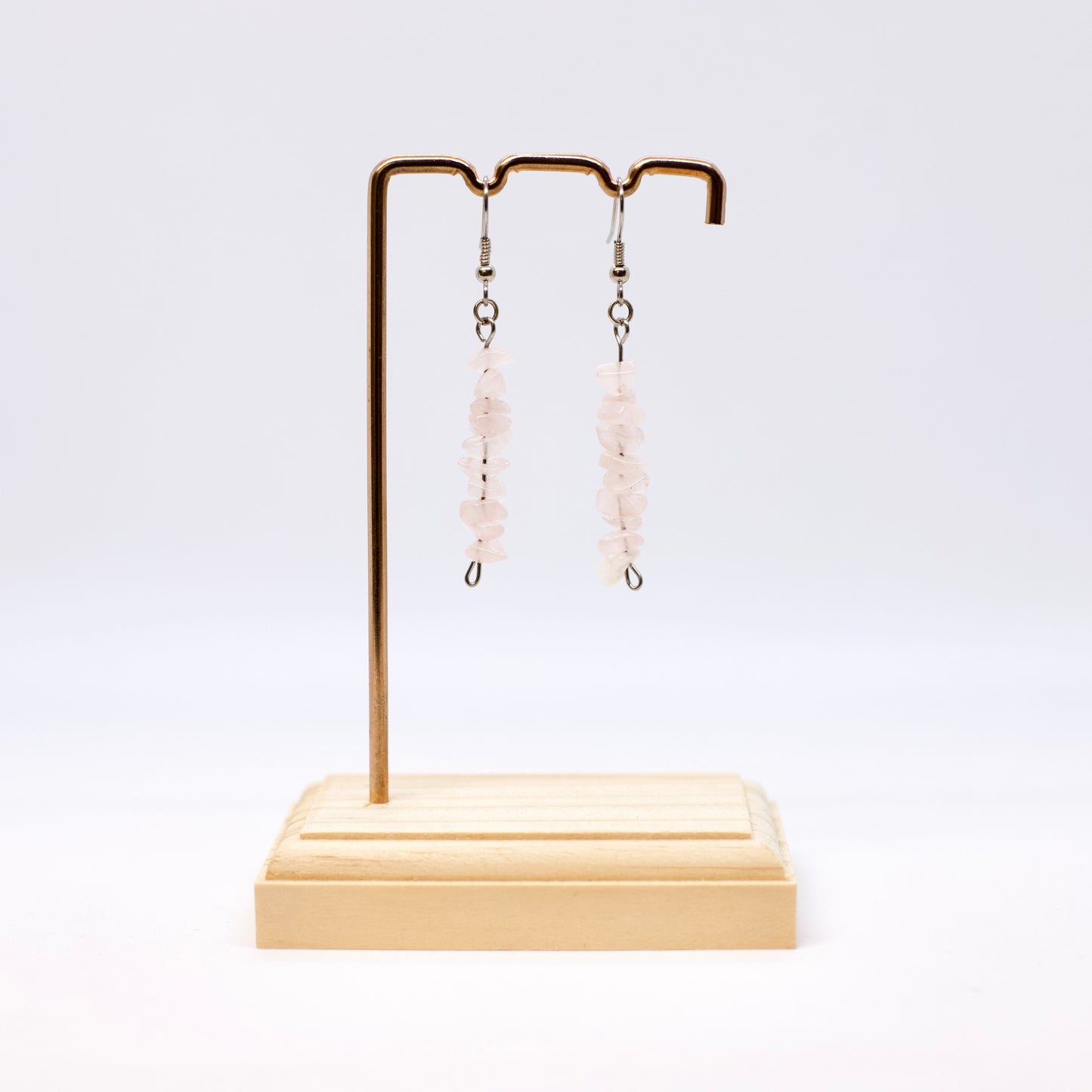 rose quartz gemstone chip earrings on display stand 