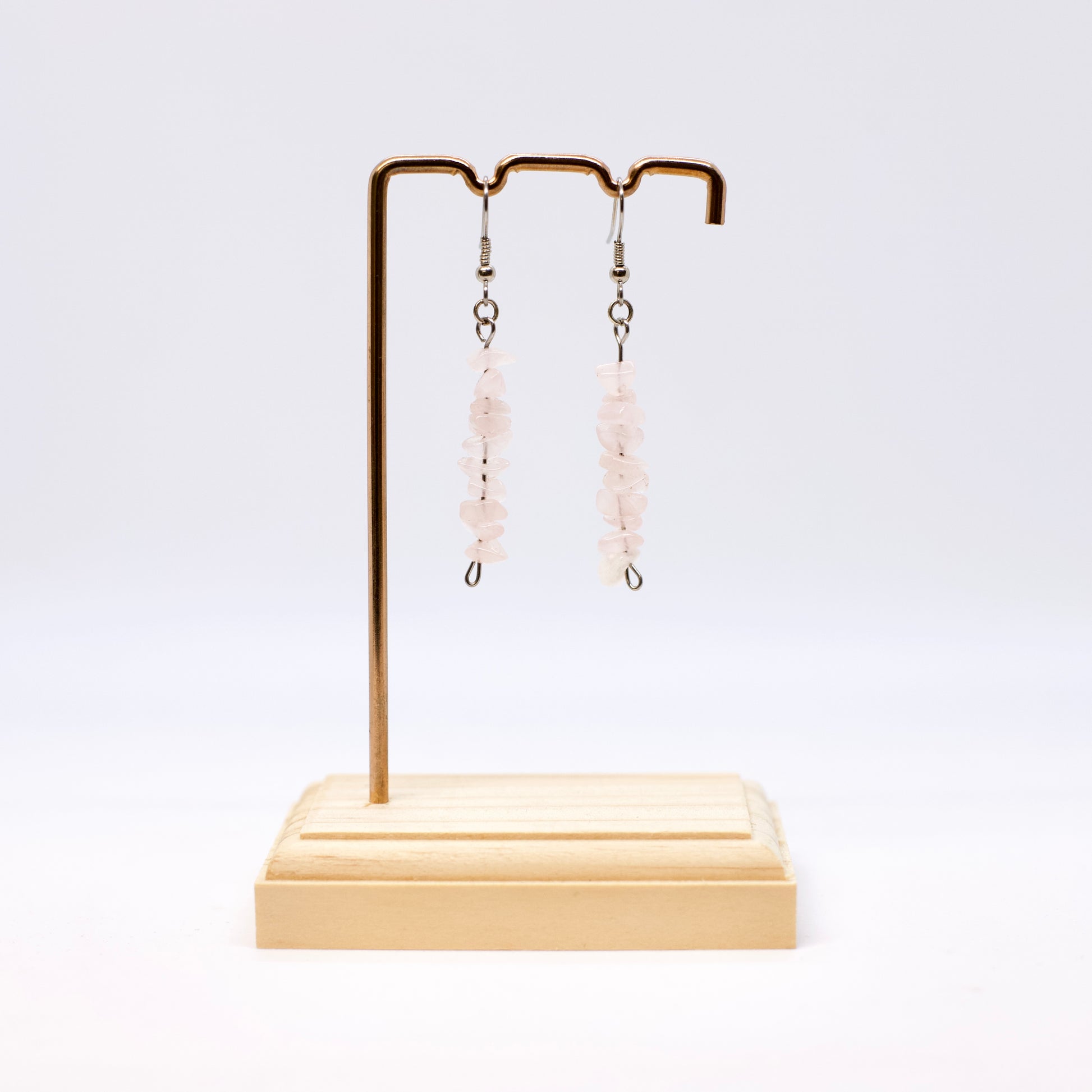 rose quartz gemstone chip earrings on display stand 