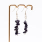 close up of Blue Goldstone earring on display stand with white background 