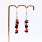 close up of Amethyst Carnelian Obsidian gemstone chip dangle earrings on stand with white background 
